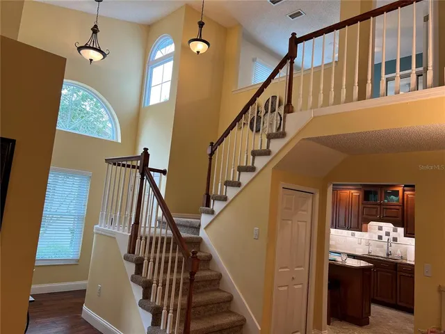a bedroom with a bed and a flat tv screen on dresser
