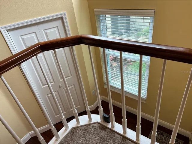 a bathroom with a granite countertop sink a toilet and mirror