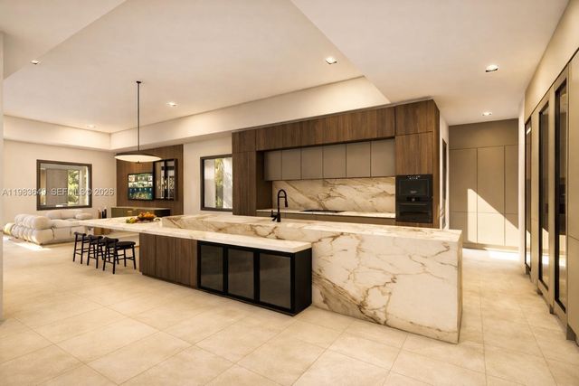 a large kitchen with kitchen island a sink stainless steel appliances and cabinets
