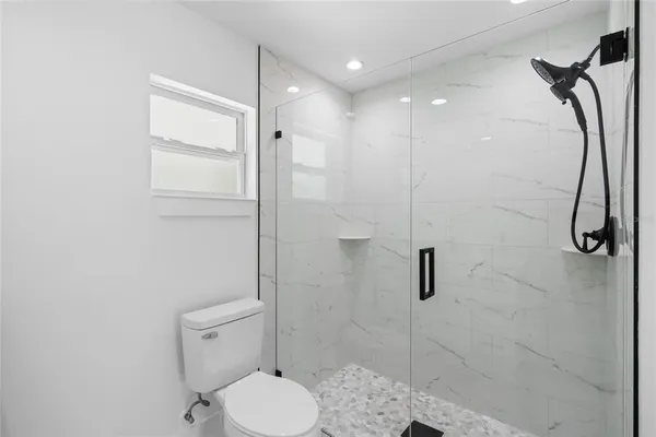 a bathroom with a toilet and a shower