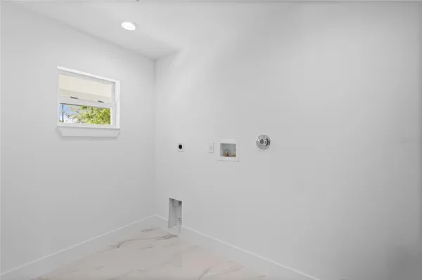 a view of a kitchen with a sink and dishwasher a stove top oven with white cabinets
