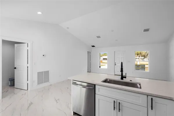 a view of a sink and mirror with window