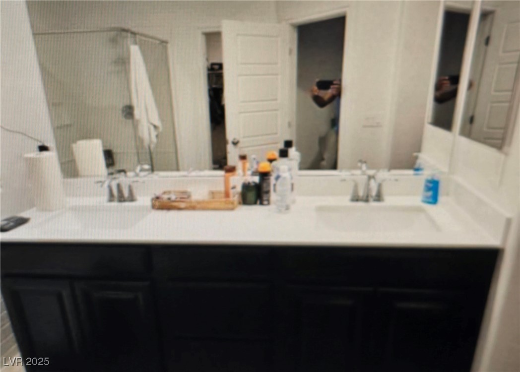 7050 Fossil Rim Street North Las Vegas, NV 89084 - Photo 13 of 19 Bathroom featuring double vanity and a stall shower