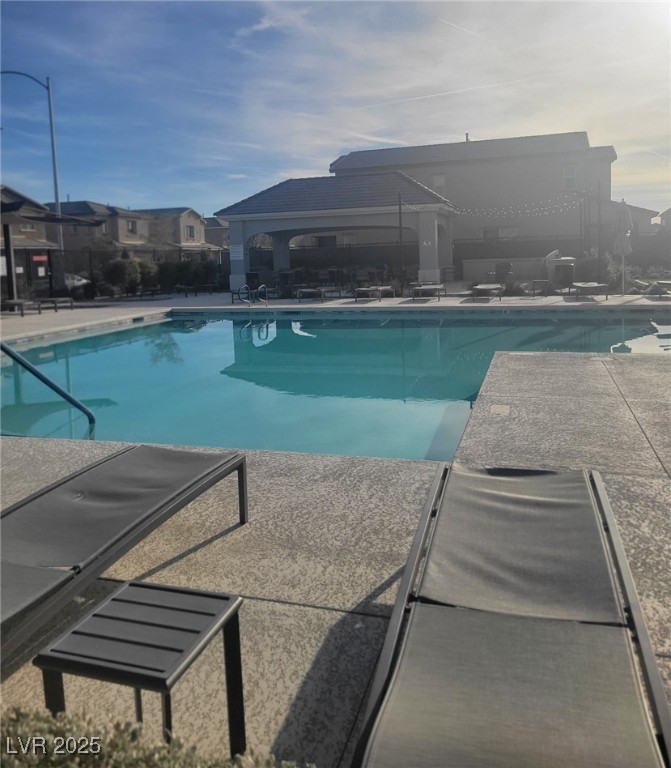 7050 Fossil Rim Street North Las Vegas, NV 89084 - Photo 15 of 19 Community pool featuring a patio area