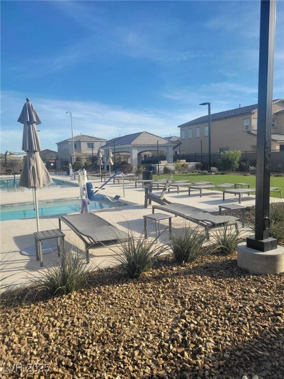 7050 Fossil Rim Street North Las Vegas, NV 89084 - Photo 16 of 19 View of home's community with a patio, a pool, and a residential view