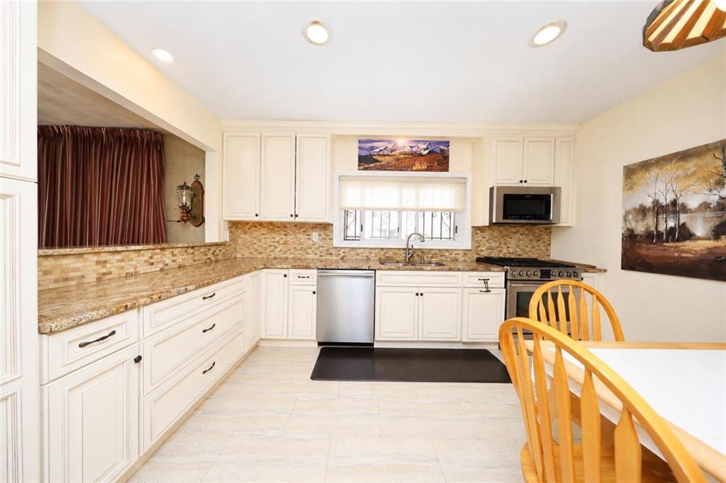 1 Bay Ridge Parkway Brooklyn, NY 11209 - Photo 15 of 38 a kitchen with granite countertop a sink and a stove top oven