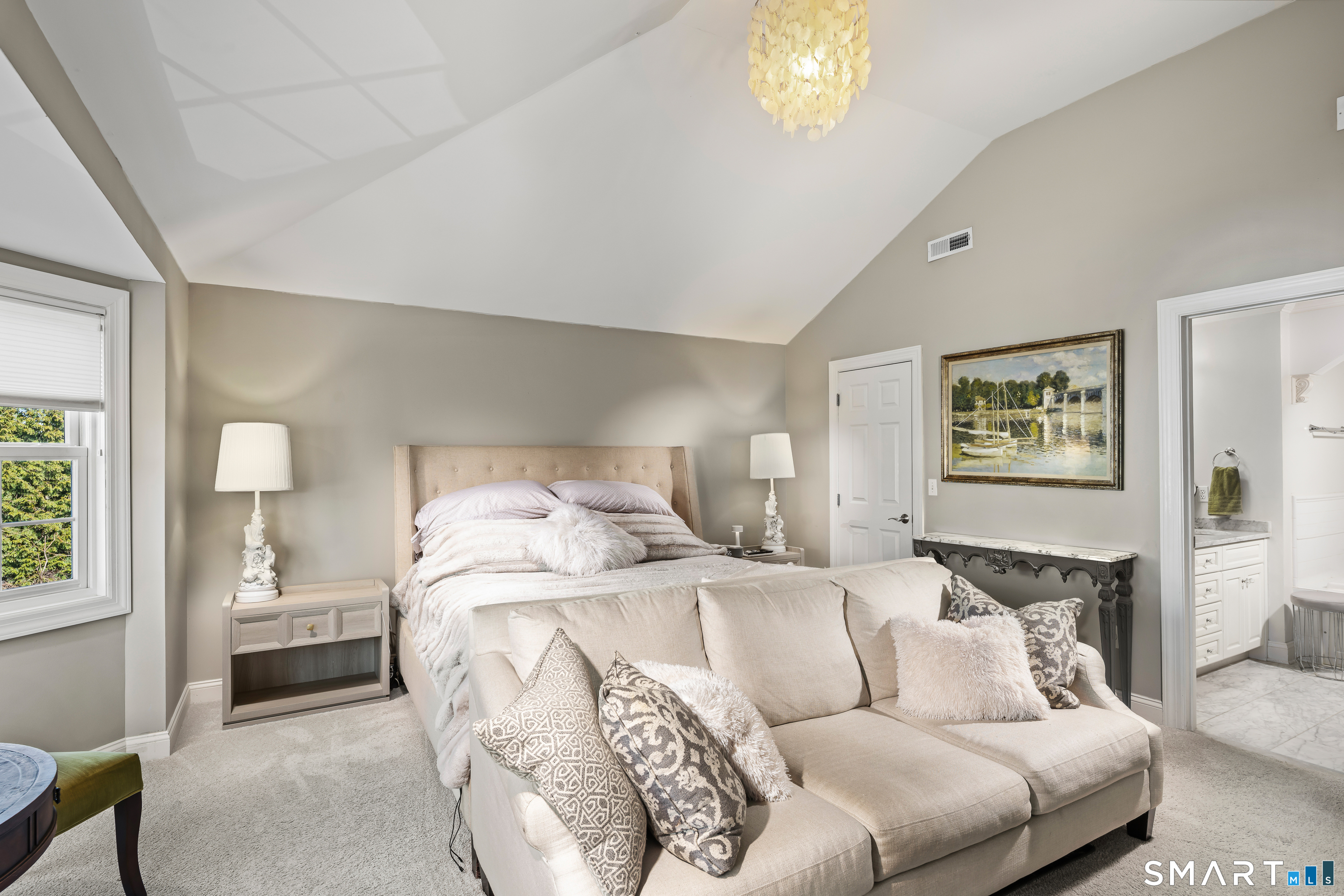 71 Aberdeen Way, Unit 71 Fairfield, CT 06890 - Photo 21 of 37 a bedroom with a bed and a chandelier
