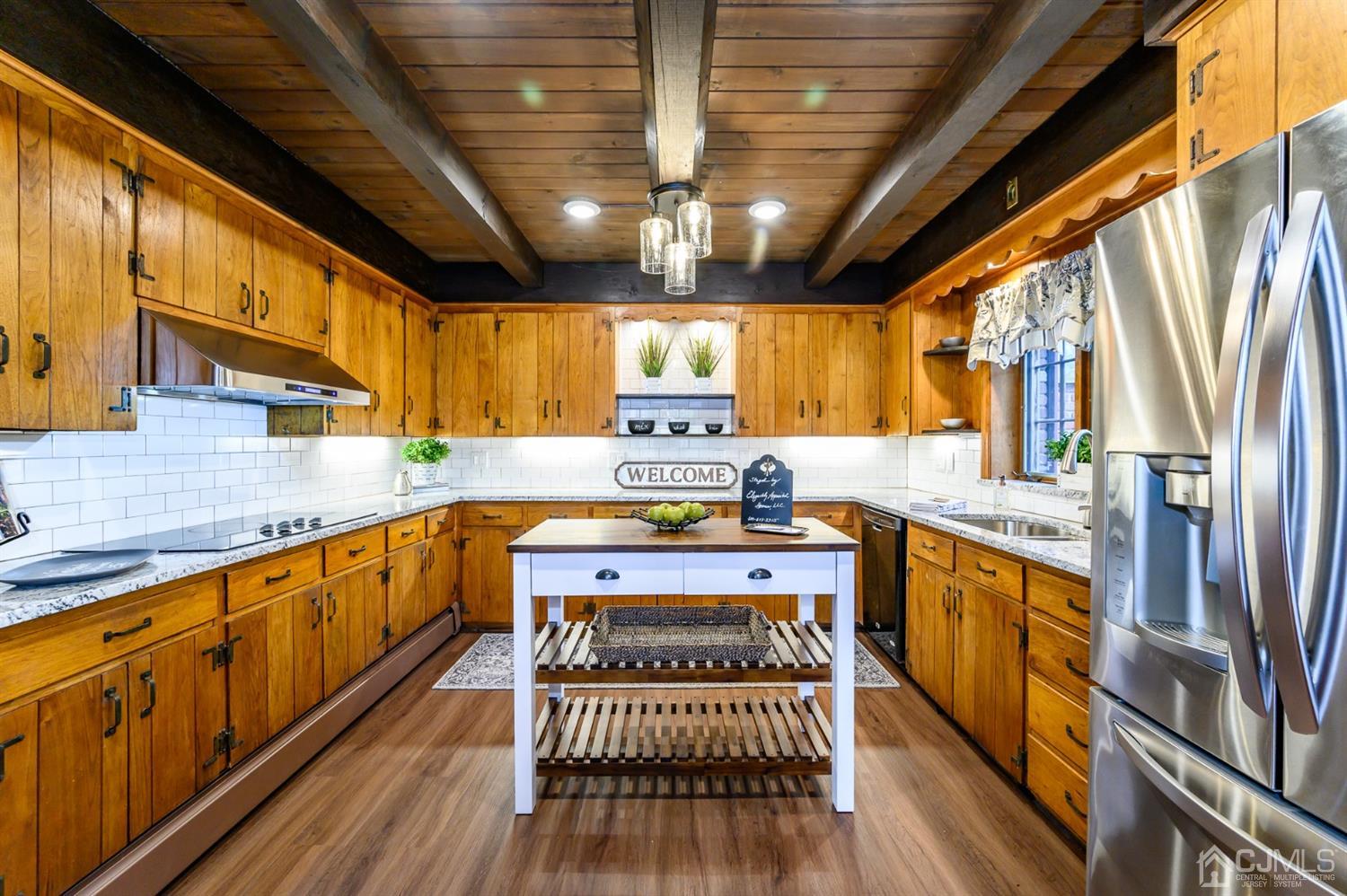 34 Mt Horeb Road Warren, NJ 07059 - Photo 29 of 55 a kitchen with stainless steel appliances granite countertop a stove a sink dishwasher and cabinets with wooden floor