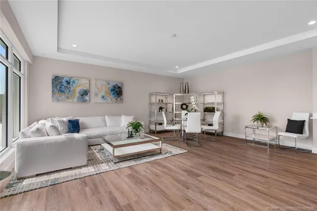 a living room with furniture and view of kitchen