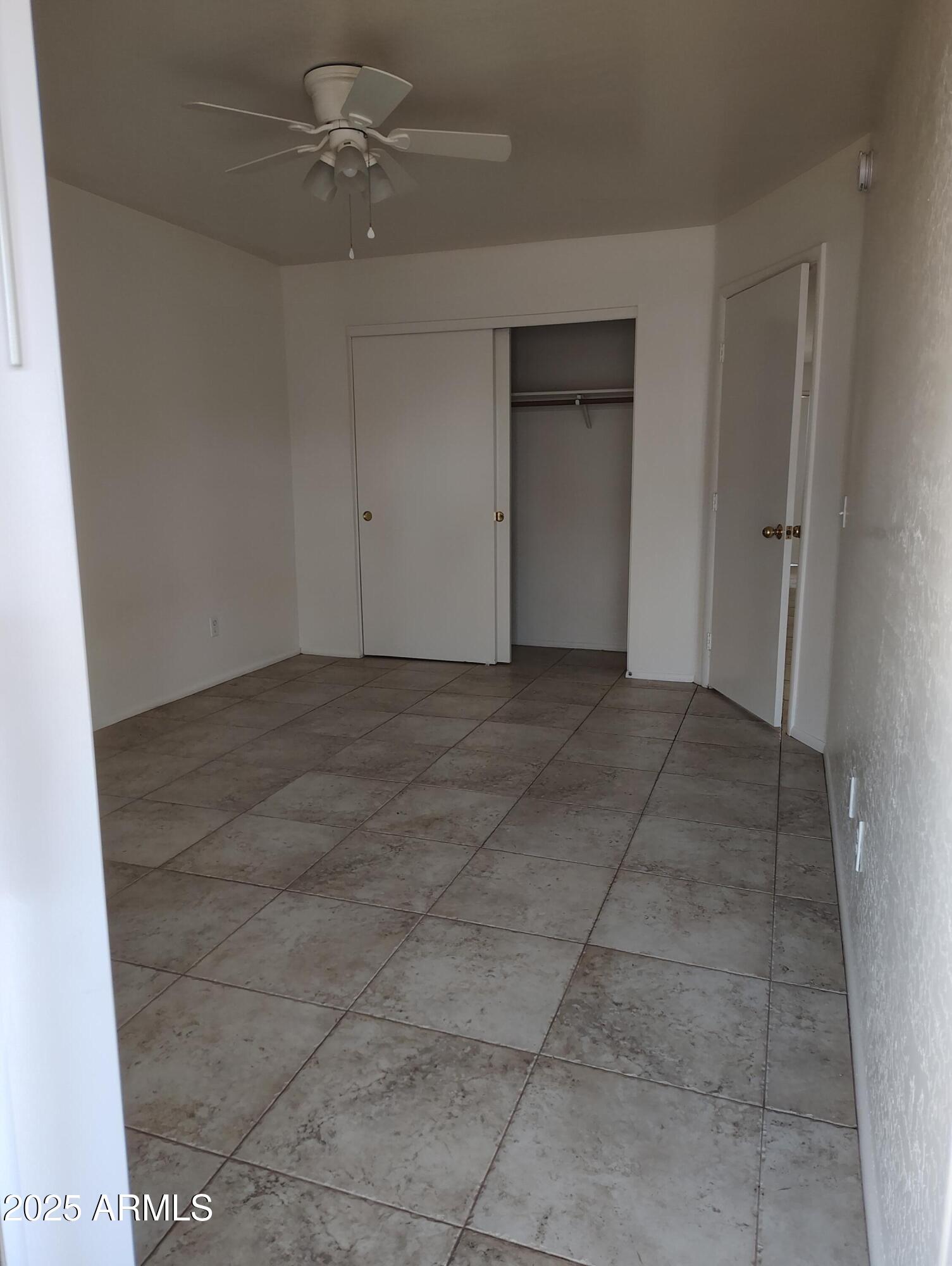 1471 East 27th Avenue, Unit 2 Apache Junction, AZ 85119 - Photo 12 of 16 a view of an empty room with a ceiling fan