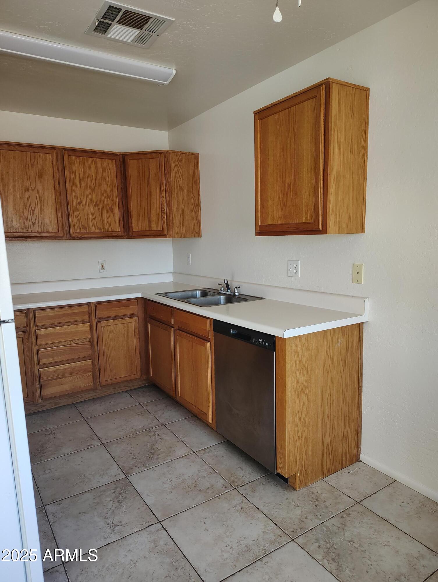 1471 East 27th Avenue, Unit 2 Apache Junction, AZ 85119 - Photo 3 of 16 a kitchen with a sink a stove and cabinets