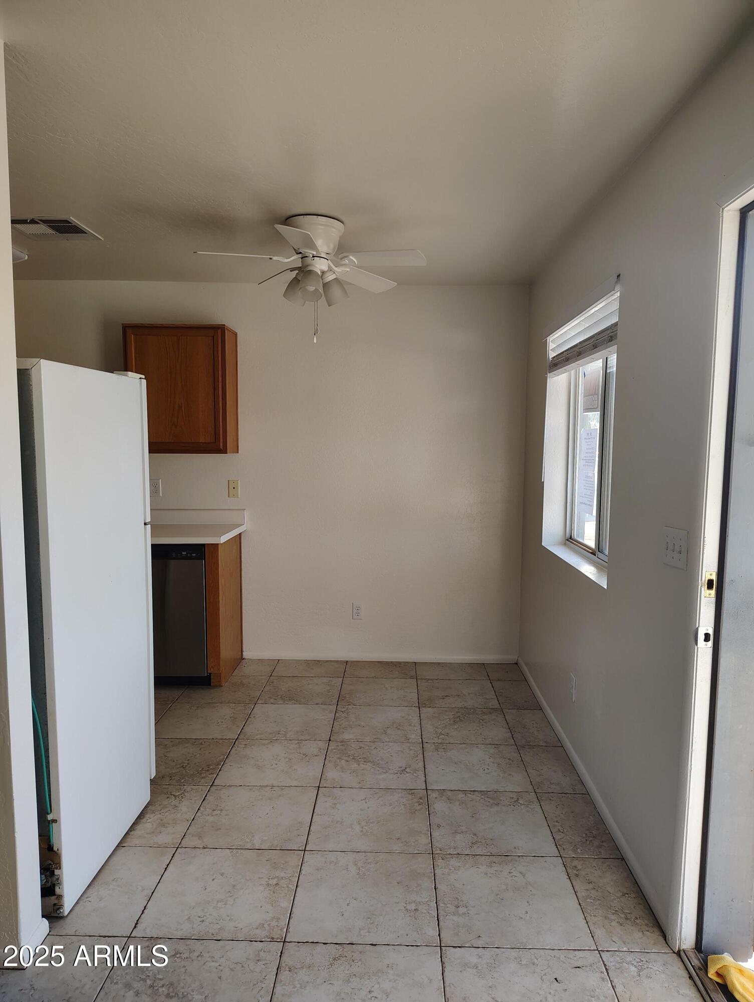 1471 East 27th Avenue, Unit 2 Apache Junction, AZ 85119 - Photo 4 of 16 wooden floor in an empty room with a kitchen