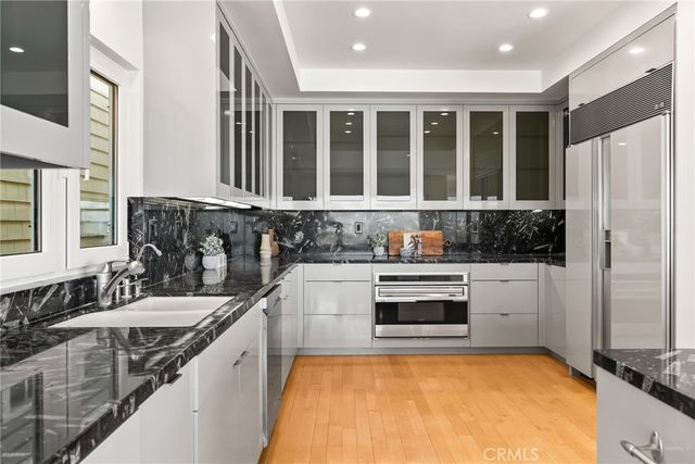 a living room with furniture a flat screen tv and a window