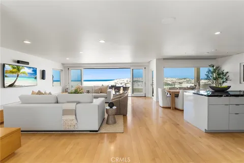 a living room with furniture and kitchen view