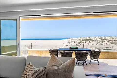 a living room with furniture and a floor to ceiling window