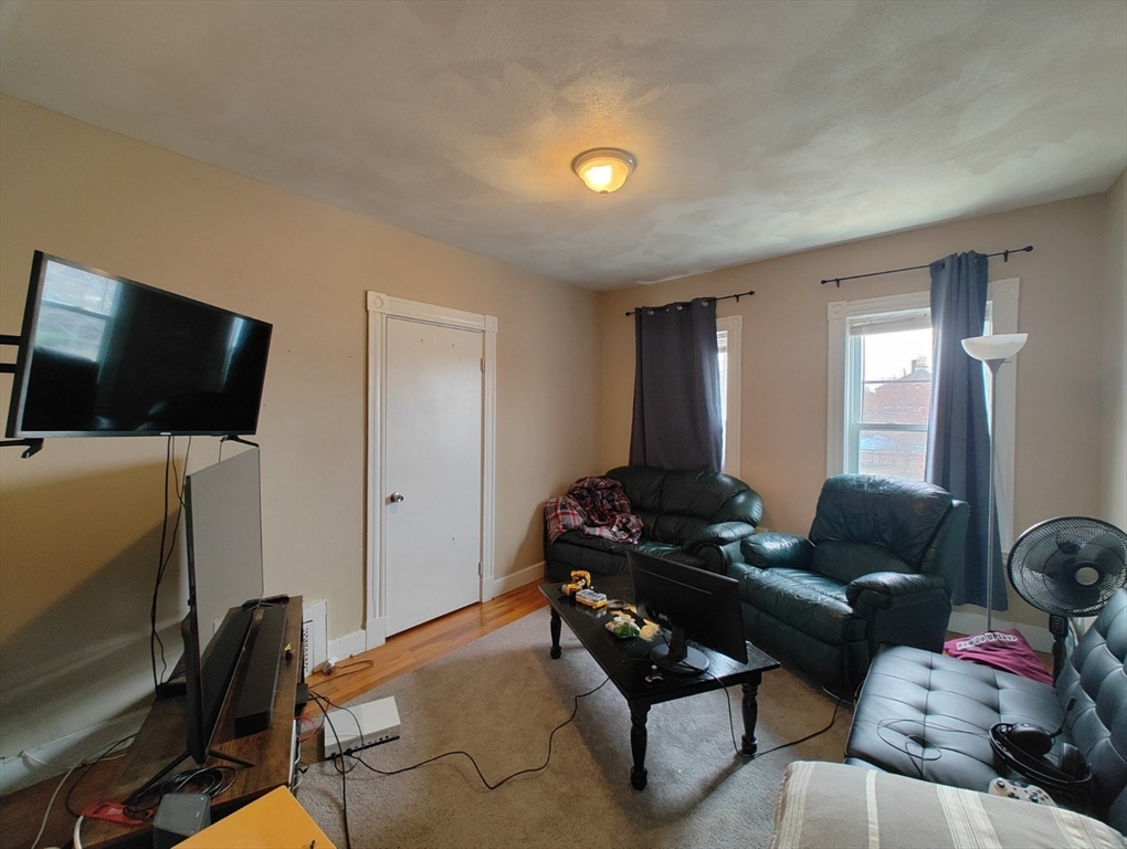 9 Medford Street, Unit 2 Medford, MA 02155 - Photo 4 of 11 a living room with furniture and a flat screen tv