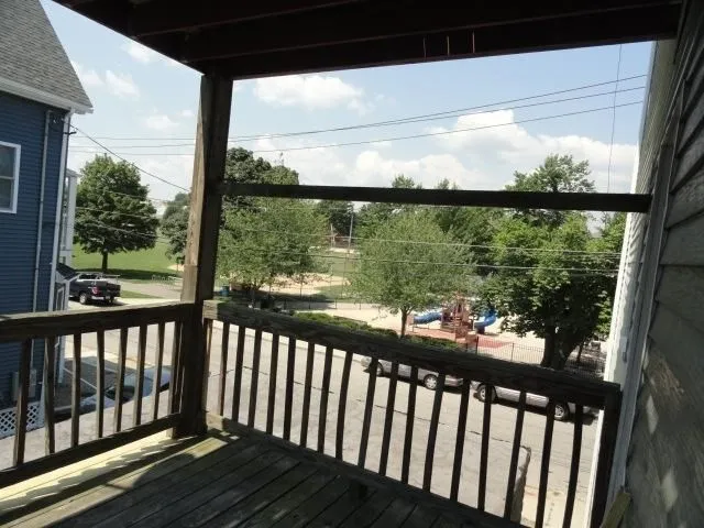 a view of a balcony with wooden floor