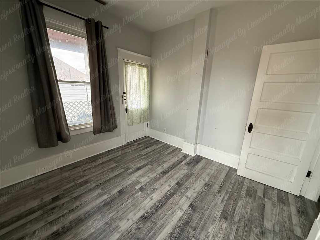 44 West High Street, Unit D Springfield, OH 45502 - Photo 20 of 25 This bright room features durable flooring and abundant natural light, creating a versatile living space.