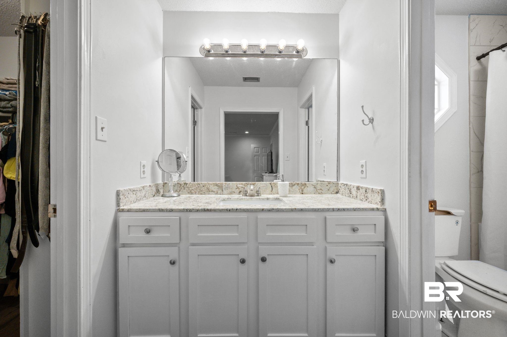 6705 Autumn Ridge Drive Mobile, AL 36695 - Photo 22 of 24 Bathroom with a shower with curtain, vanity, a textured ceiling, and toilet