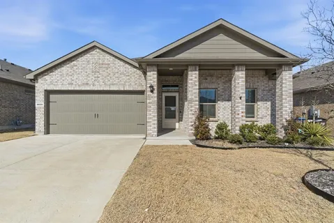 front view of a house with potted plants
