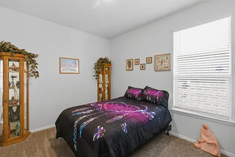 a bedroom with a bed and a window