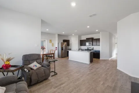a living room with furniture and kitchen view