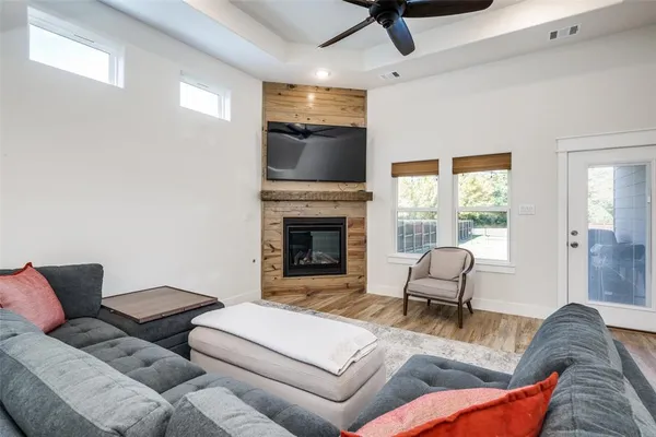 a living room with furniture a flat screen tv and a fireplace