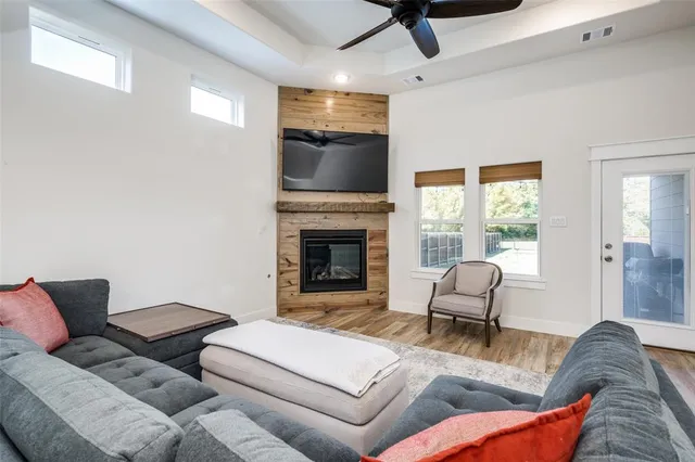 a living room with furniture a flat screen tv and a fireplace