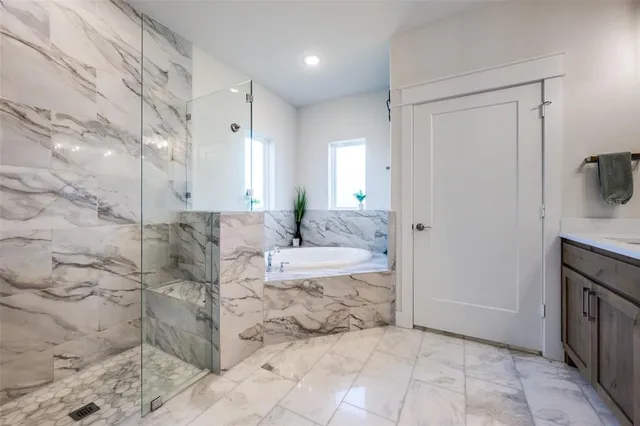 a spacious bathroom with a granite countertop tub sink and mirror