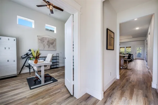 a view of a workspace with furniture and wooden floor