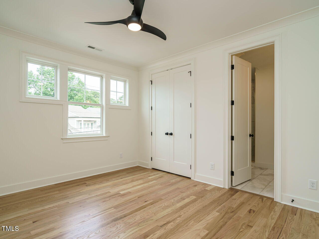 1706 Center Road Raleigh, NC 27608 - Photo 23 of 44 a view of an empty room with wooden floor and a window