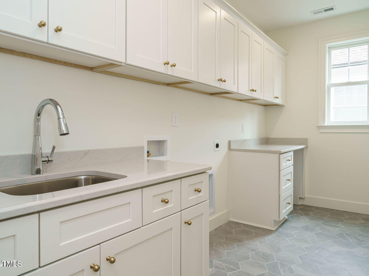 1706 Center Road Raleigh, NC 27608 - Photo 27 of 44 a kitchen with white cabinets and a sink