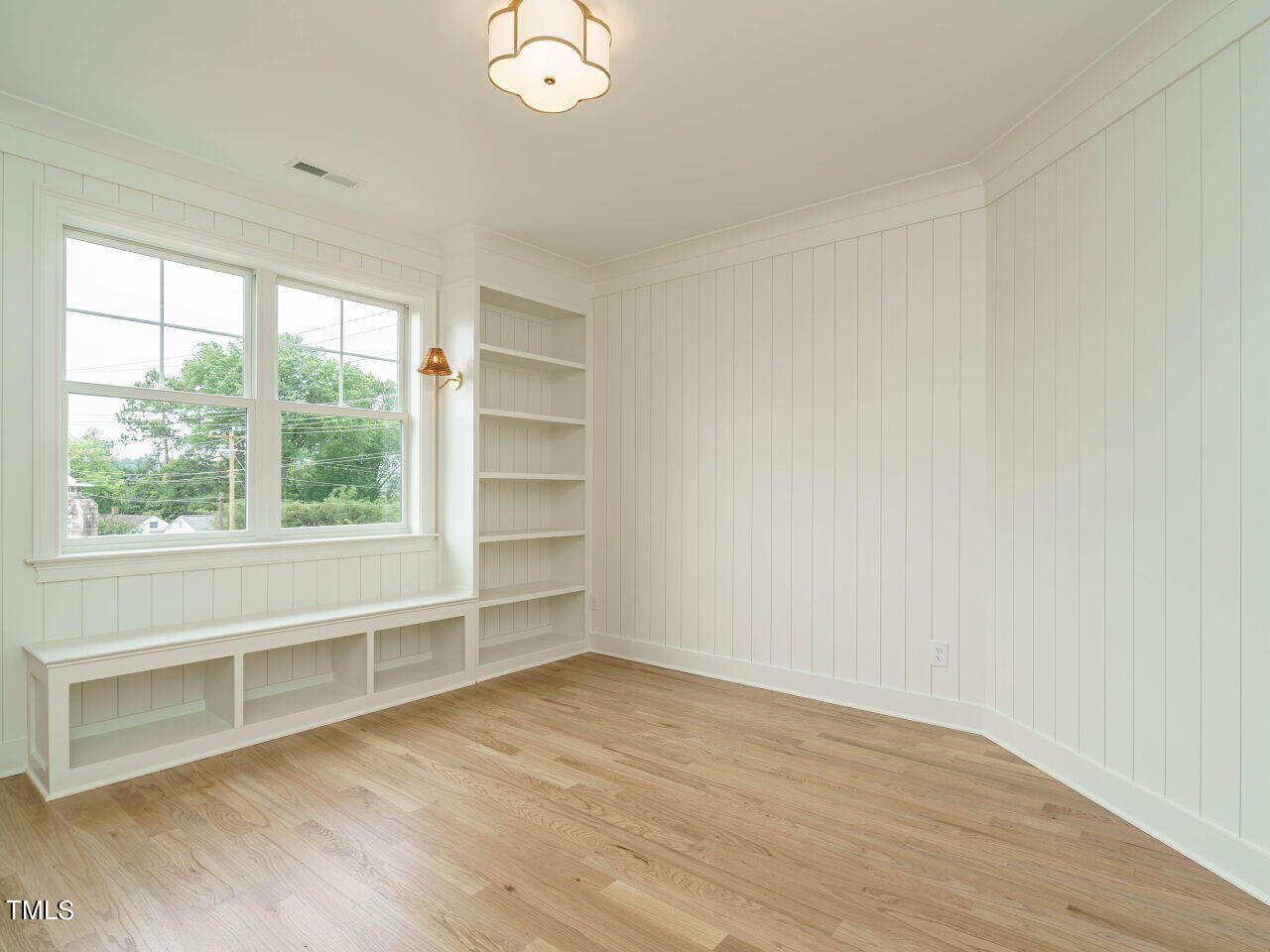 1706 Center Road Raleigh, NC 27608 - Photo 28 of 44 an empty room with wooden floor and windows