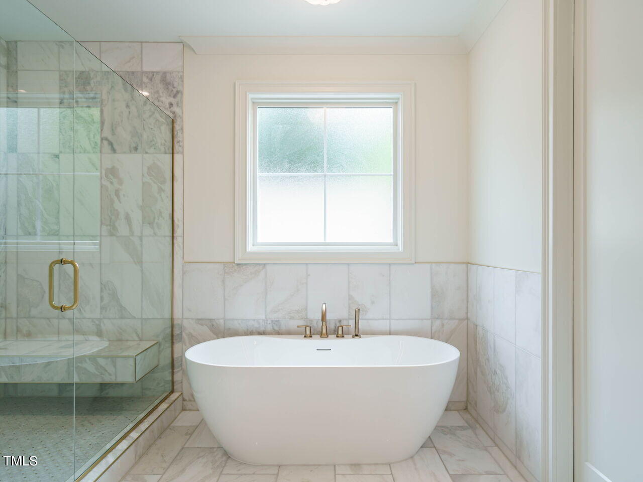 1706 Center Road Raleigh, NC 27608 - Photo 34 of 44 a white bath tub sitting in a bathroom next to a window