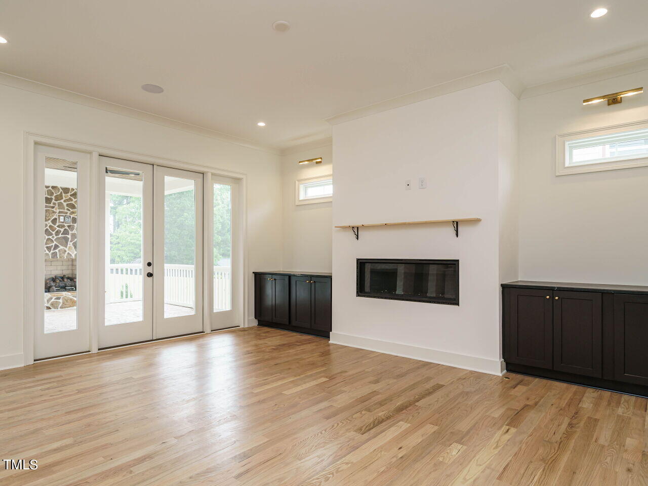 1706 Center Road Raleigh, NC 27608 - Photo 6 of 44 a view of an empty room with a fireplace and a window