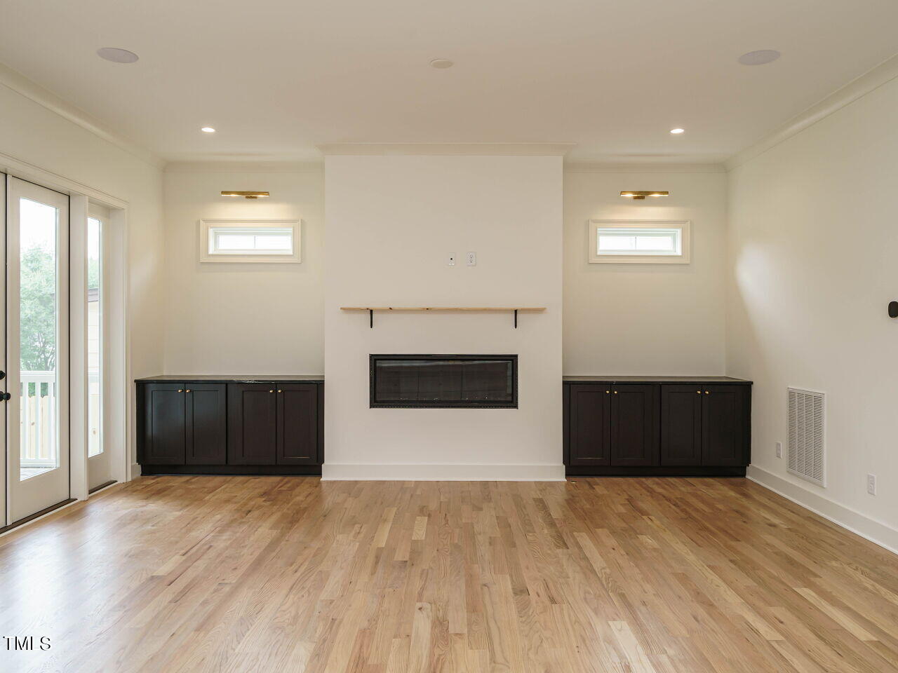 1706 Center Road Raleigh, NC 27608 - Photo 7 of 44 an empty room with wooden floor and white walls