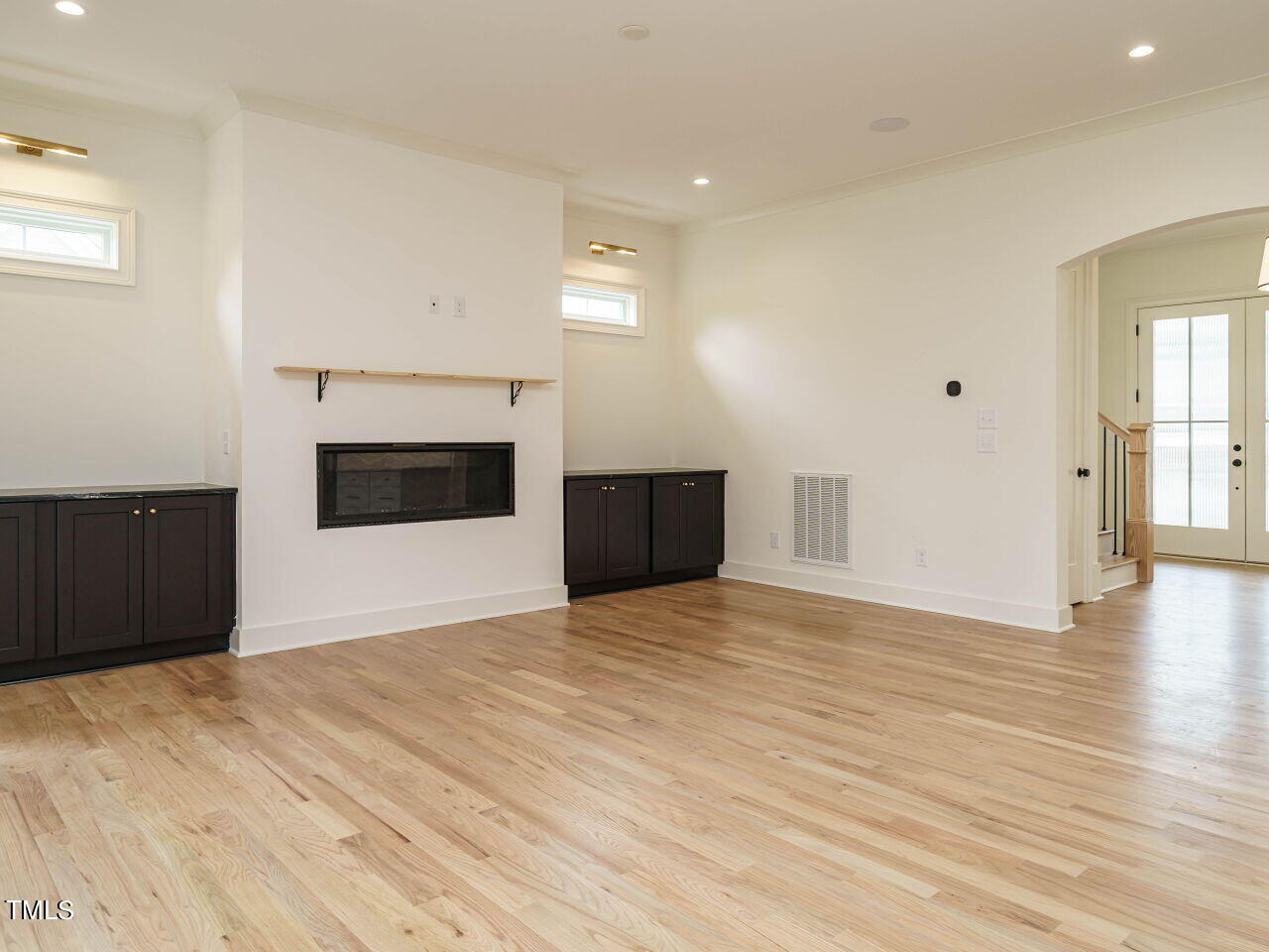 1706 Center Road Raleigh, NC 27608 - Photo 8 of 44 a view of empty room with wooden floor and fireplace