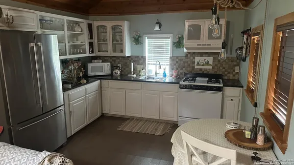 a kitchen with stainless steel appliances a sink and a refrigerator