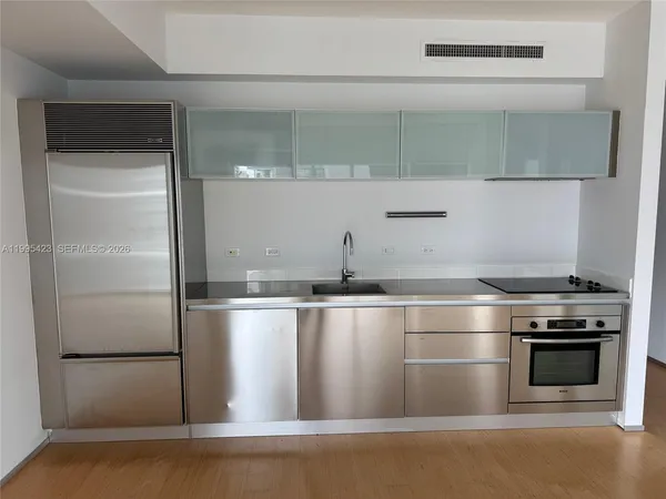 a kitchen with stainless steel appliances wooden cabinets and stove
