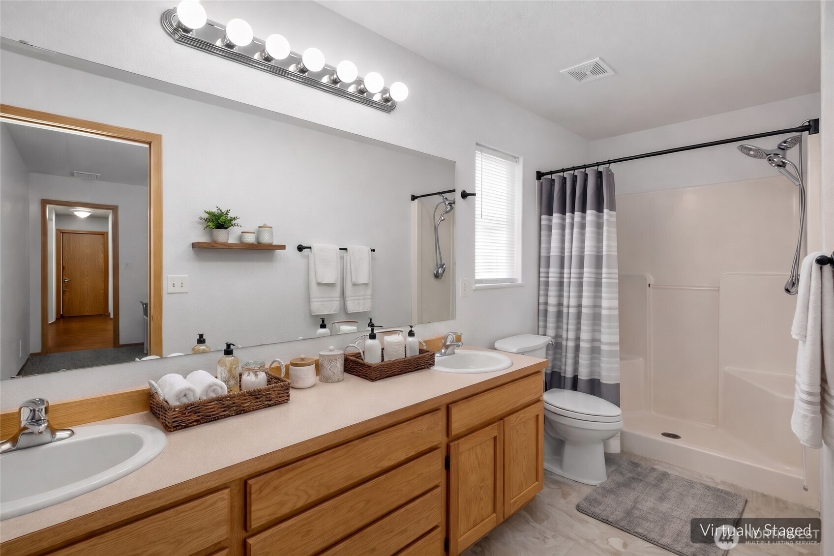 7606 187th Avenue Southwest Rochester, WA 98579 - Photo 16 of 28 a bathroom with double sink and a mirror