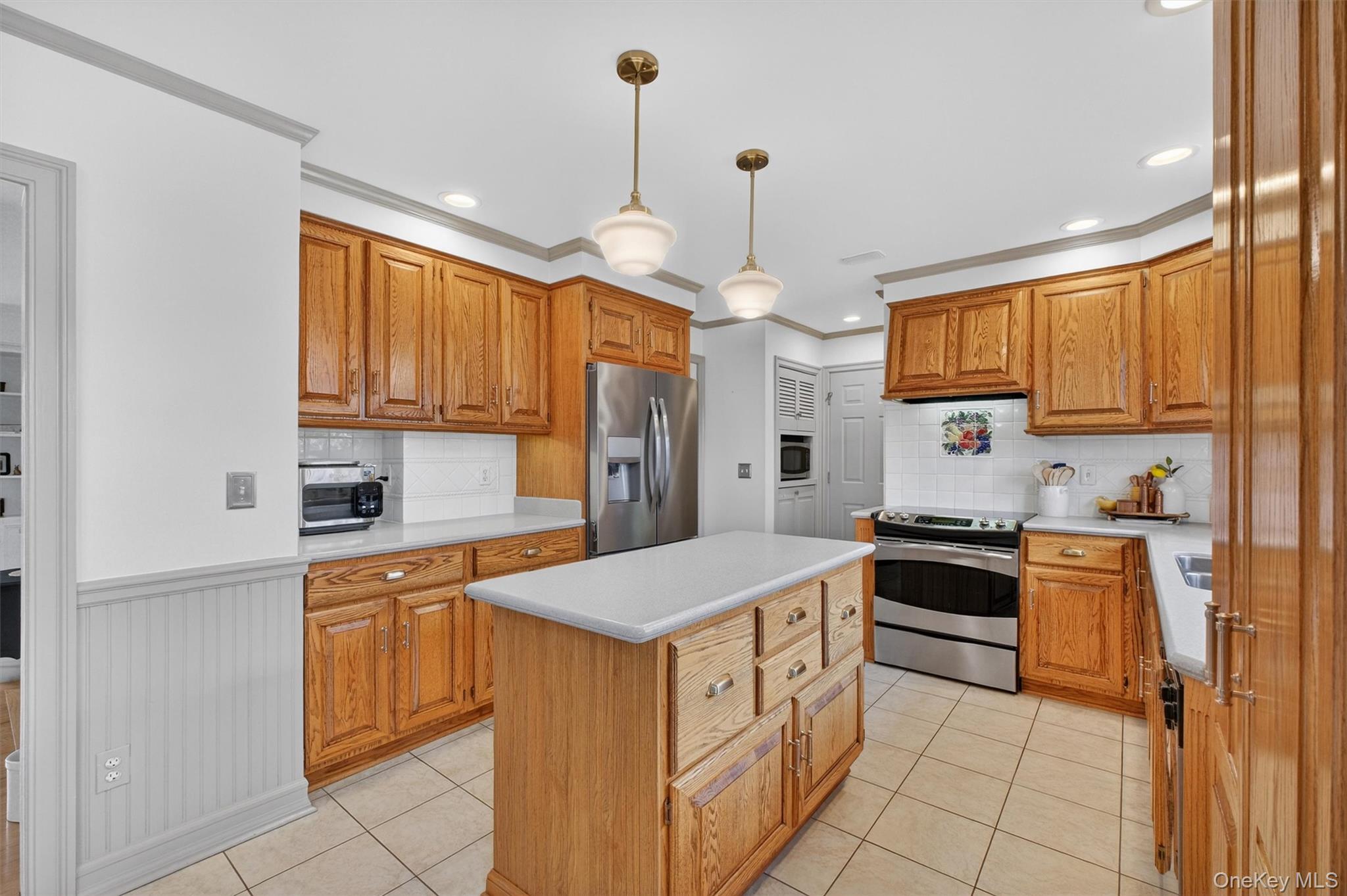 58 Dutchess Hill Road Poughkeepsie, NY 12601 - Photo 12 of 50 Open, bright kitchen with loads of cabinets, center island, corian counters and SS appliances