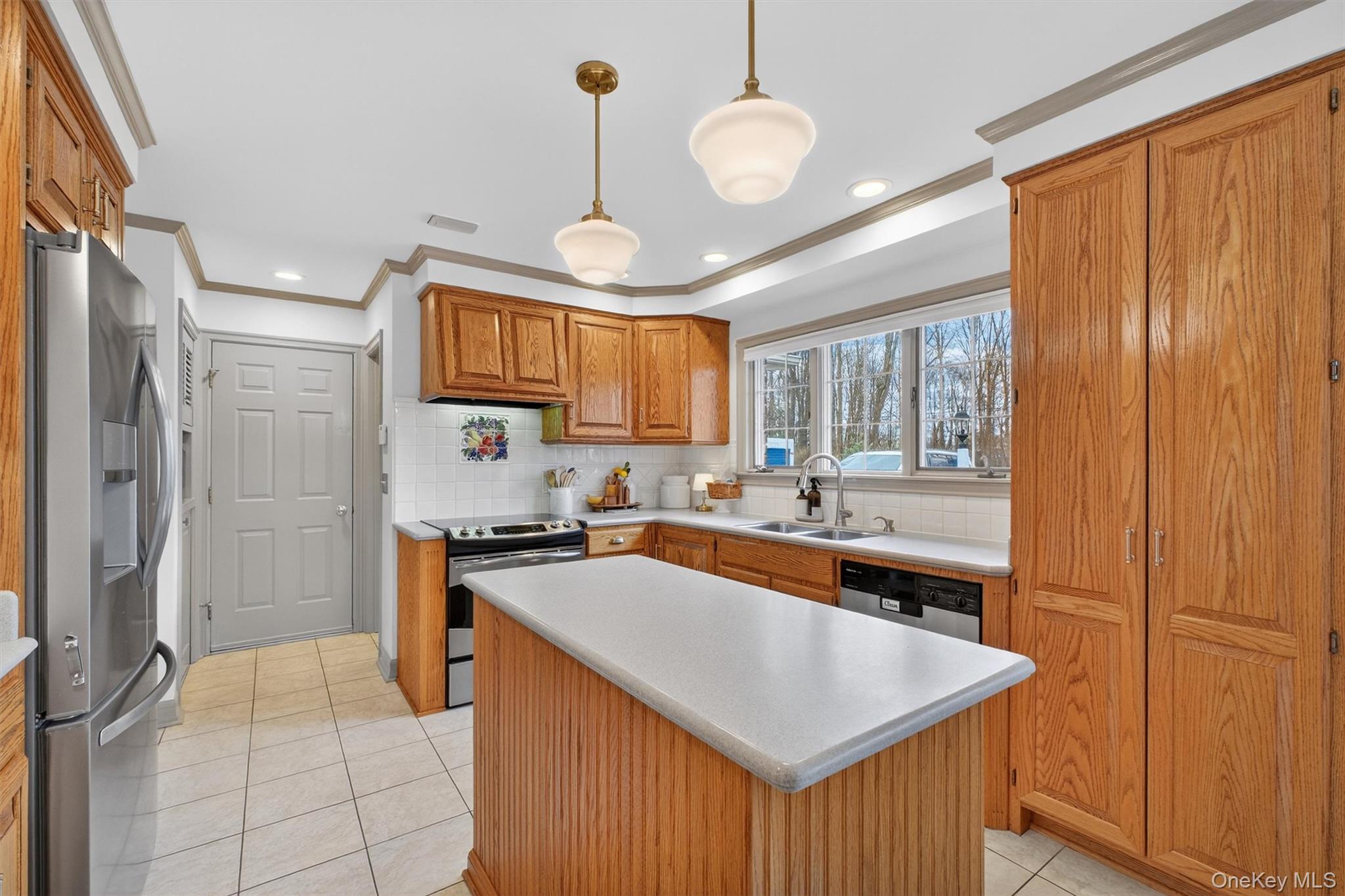 58 Dutchess Hill Road Poughkeepsie, NY 12601 - Photo 13 of 50 Open, bright kitchen with loads of cabinets, center island, corian counters and SS appliances
