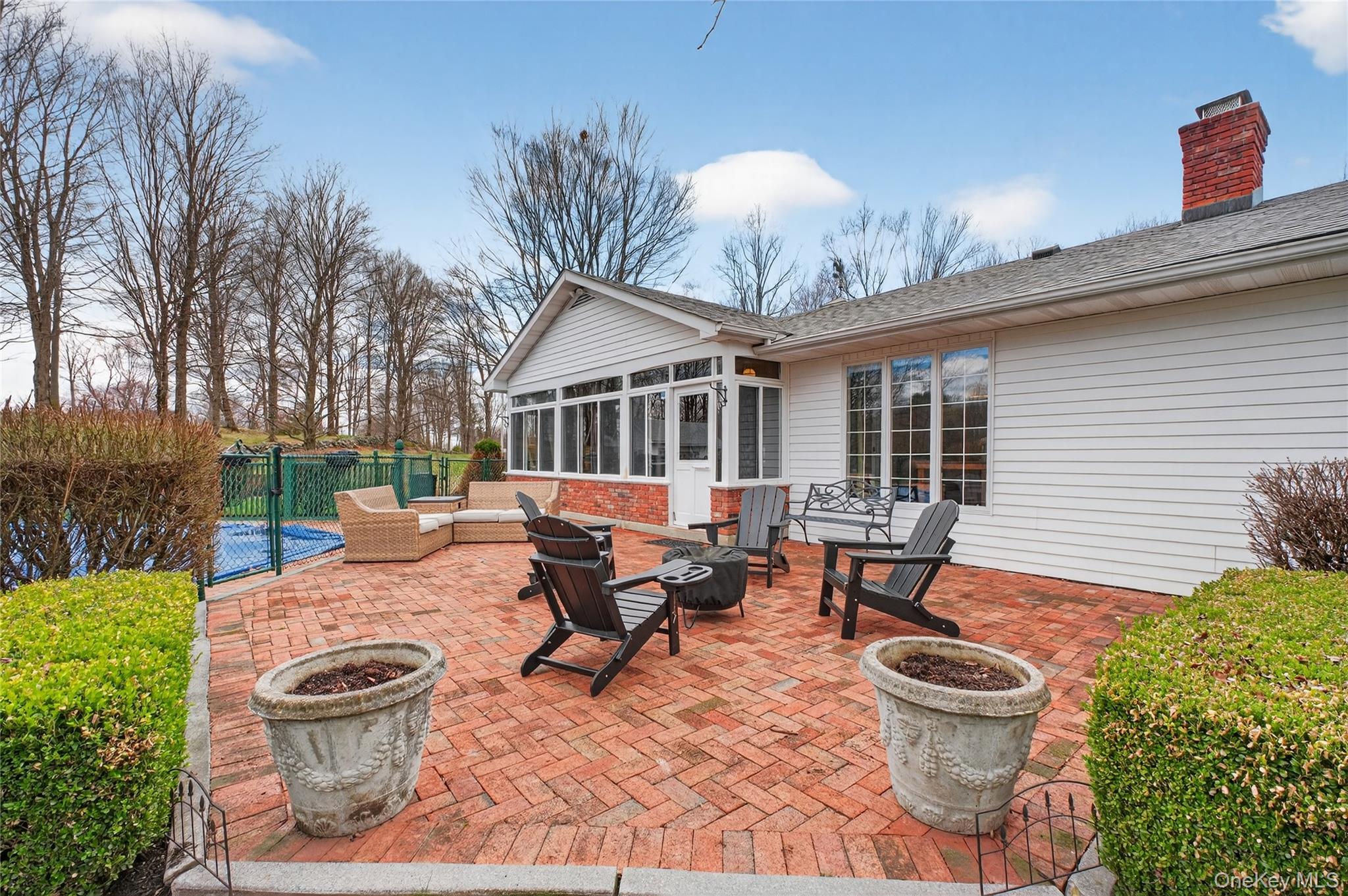 58 Dutchess Hill Road Poughkeepsie, NY 12601 - Photo 36 of 50 Expansive brick patio across the back of the home to the entrance of the pool area