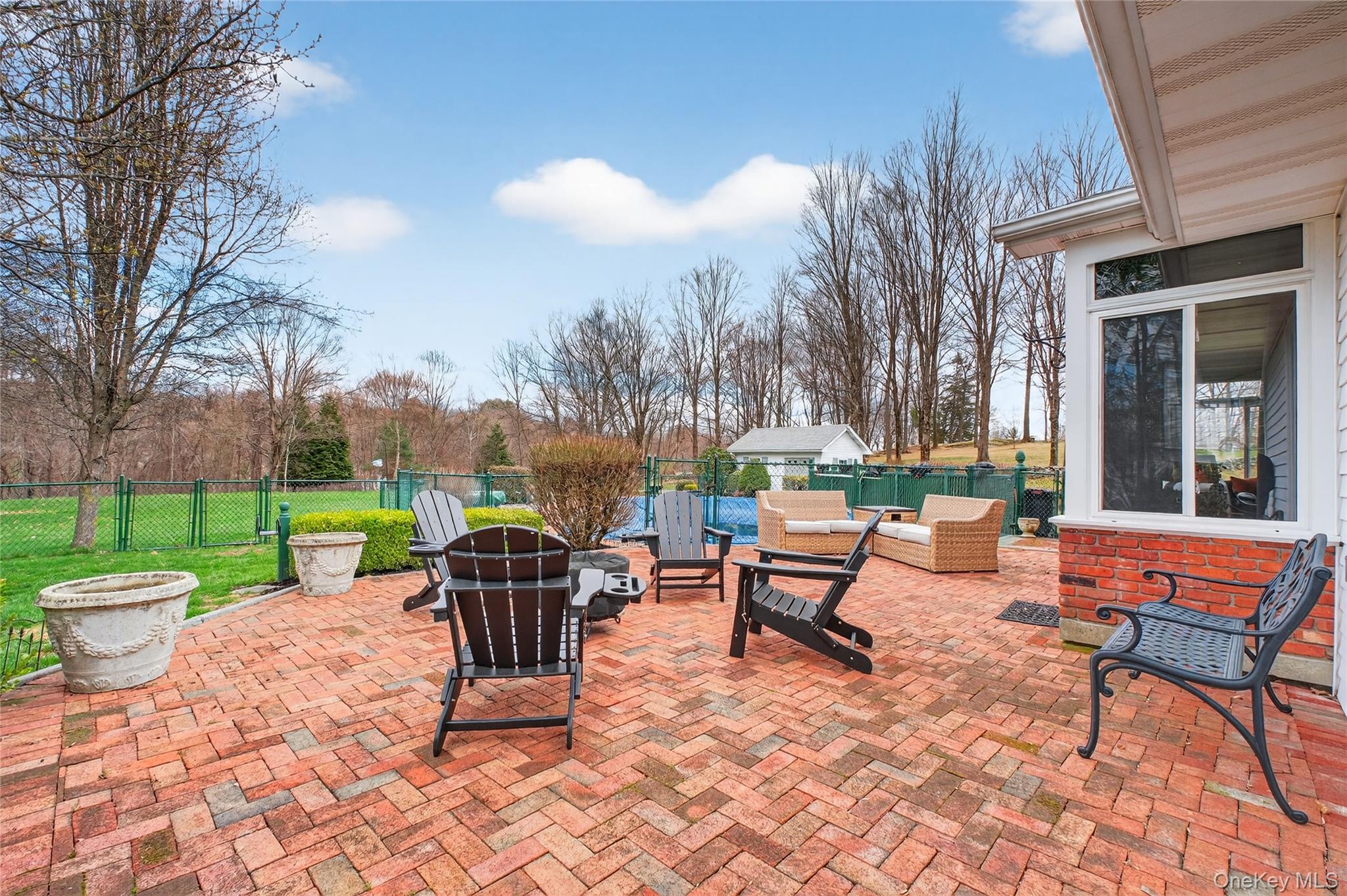 58 Dutchess Hill Road Poughkeepsie, NY 12601 - Photo 37 of 50 Expansive brick patio across the back of the home to the entrance of the pool area