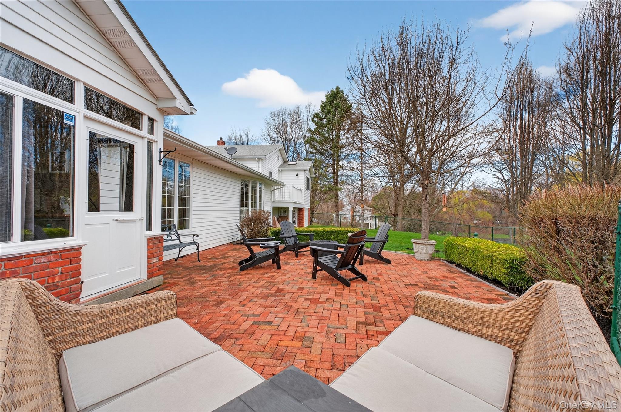 58 Dutchess Hill Road Poughkeepsie, NY 12601 - Photo 38 of 50 Expansive brick patio across the back of the home to the entrance of the pool area
