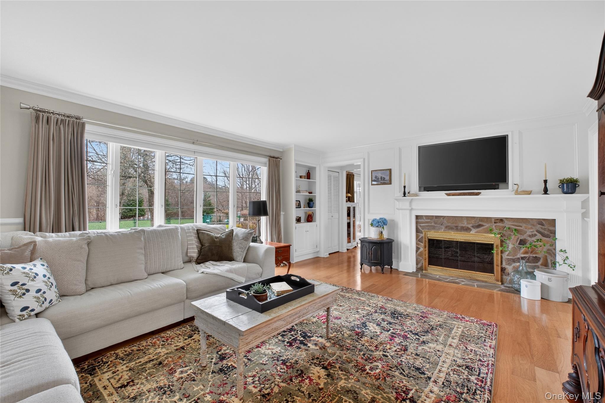 58 Dutchess Hill Road Poughkeepsie, NY 12601 - Photo 5 of 50 Spacious living room with hardwood floors, fieldstone fireplace, custom moldings and large windows