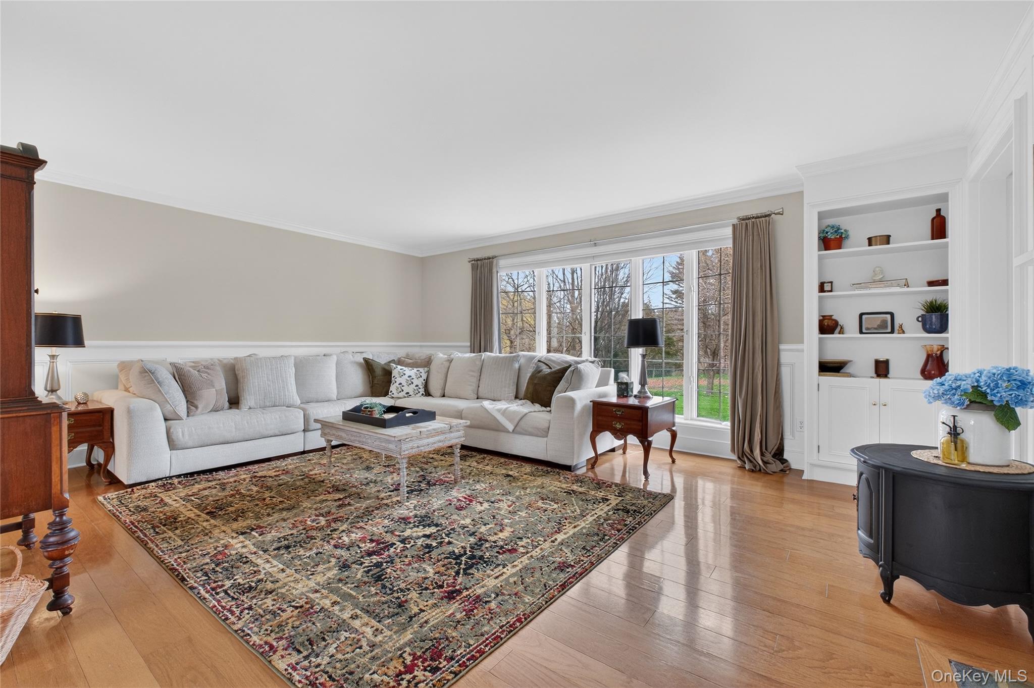 58 Dutchess Hill Road Poughkeepsie, NY 12601 - Photo 6 of 50 Spacious living room with hardwood floors, fieldstone fireplace, custom moldings and large windows