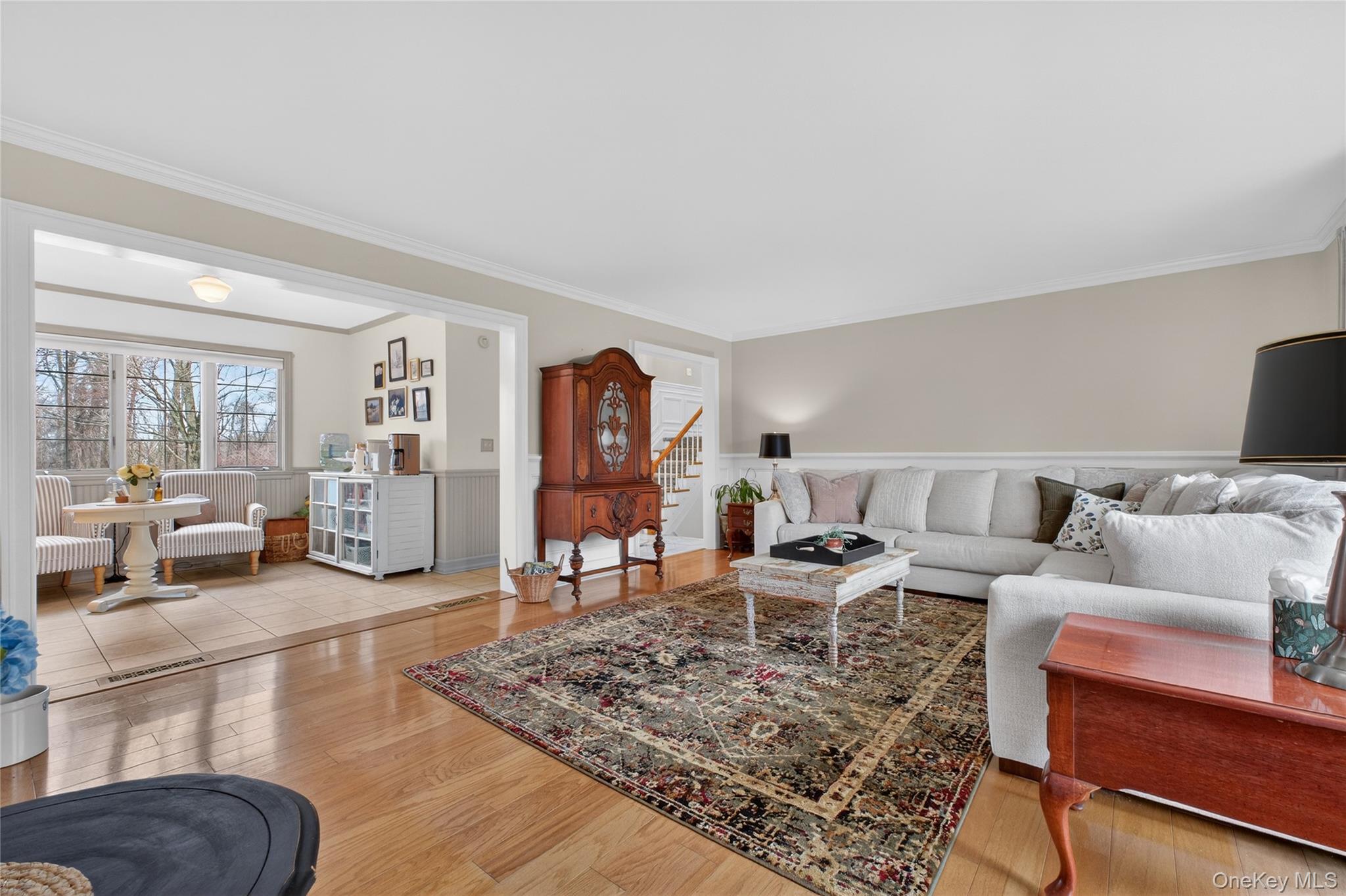58 Dutchess Hill Road Poughkeepsie, NY 12601 - Photo 7 of 50 Spacious living room with hardwood floors, fieldstone fireplace, custom moldings and large windows