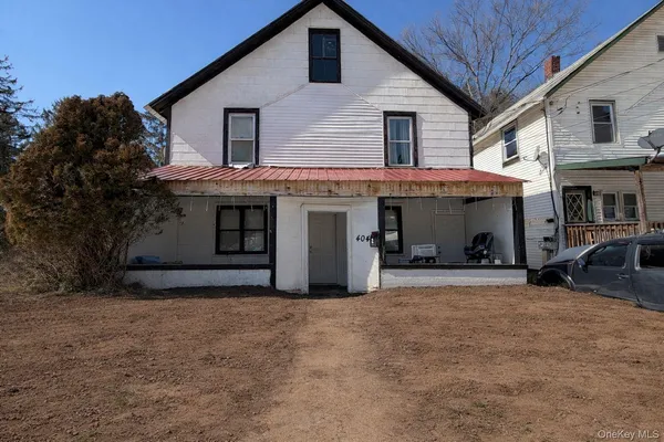 a view of a house with a yard and garage