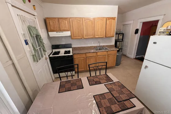a kitchen with sink refrigerator and microwave
